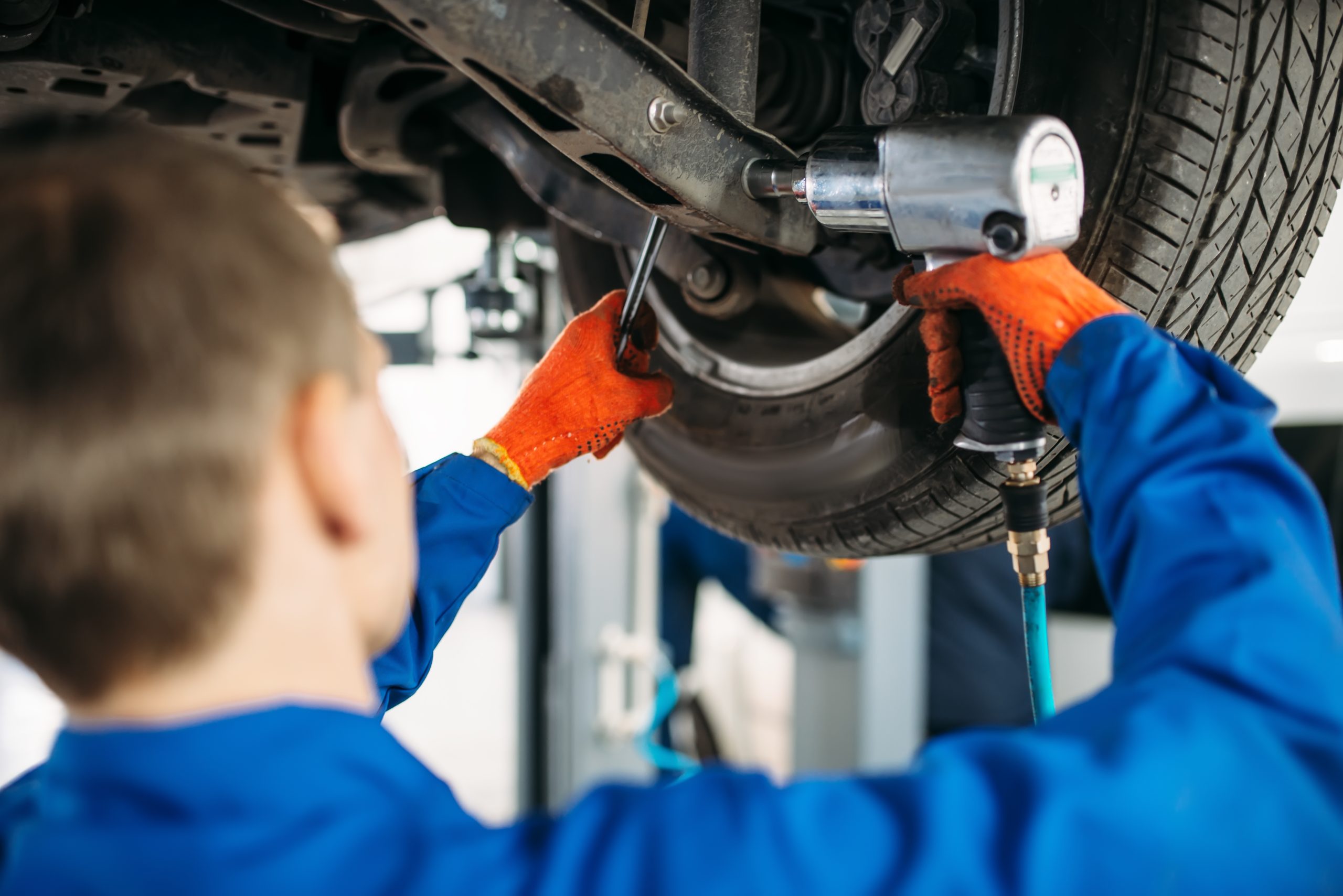 technician with a wrench repair car suspension 2021 08 26 16 26 36 utc scaled